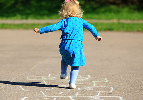 Create a hopscotch course with colored tape on the floor, or draw the course on the sidewalk with colored chalk.