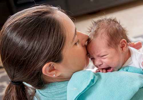 Try holding your baby close to you and repeat the same sounds and movements over and over.