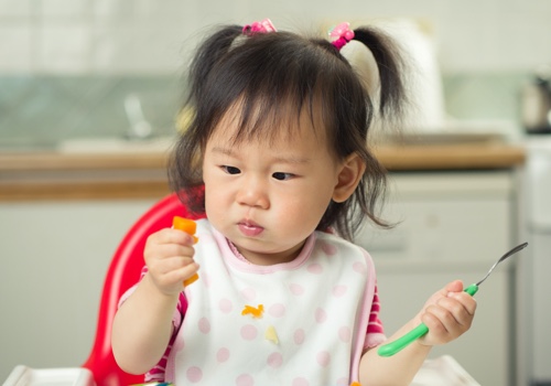 Trying foods many times before deciding if she likes them.